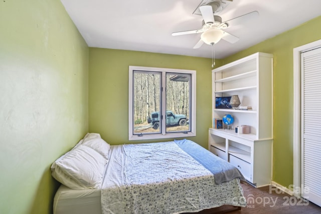 bedroom featuring ceiling fan and baseboards