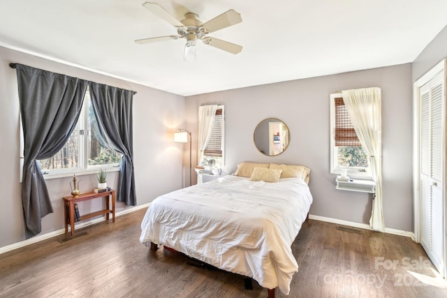 bedroom with a closet, baseboards, and wood finished floors