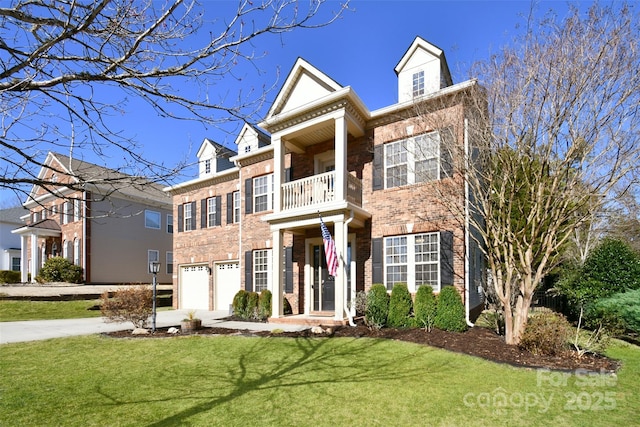 view of front of property with brick siding, a front yard, a balcony, a garage, and driveway