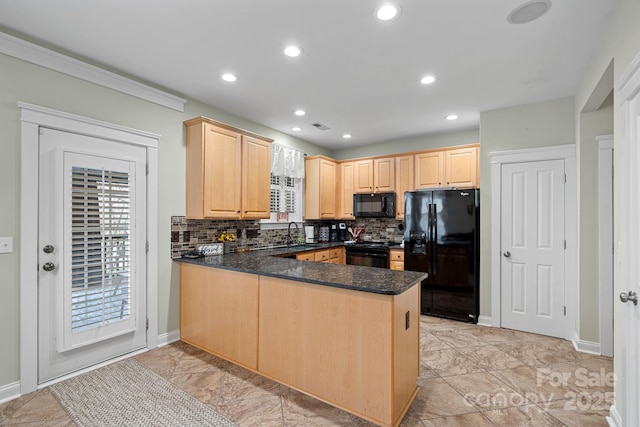 kitchen with a sink, black appliances, a peninsula, and light brown cabinets