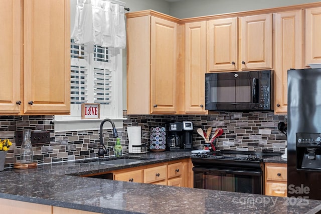 kitchen with decorative backsplash, light brown cabinetry, a sink, dark stone countertops, and black appliances