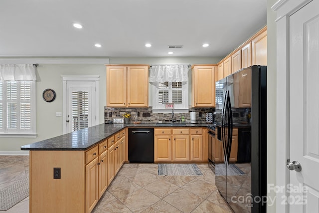 kitchen featuring light brown cabinets, a peninsula, a sink, backsplash, and black appliances