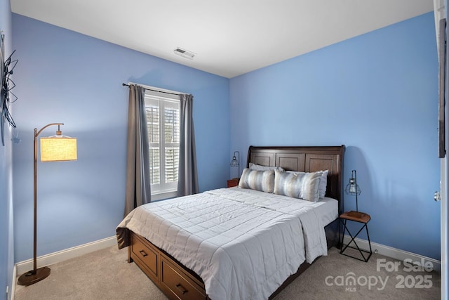 bedroom featuring baseboards, visible vents, and light colored carpet