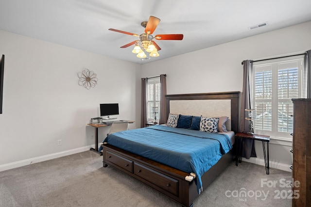 bedroom with multiple windows, carpet flooring, visible vents, and baseboards