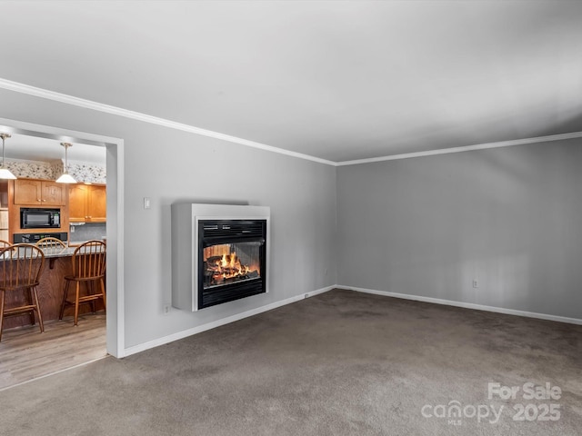 unfurnished living room featuring carpet, baseboards, crown molding, and a multi sided fireplace