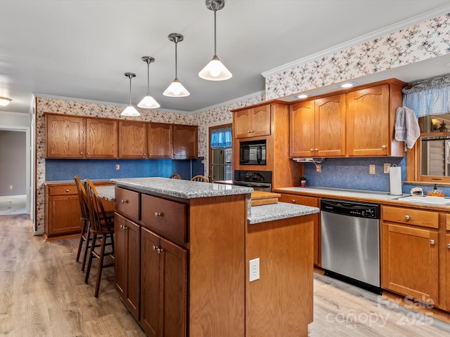 kitchen with a kitchen island, ornamental molding, appliances with stainless steel finishes, light wood-type flooring, and wallpapered walls