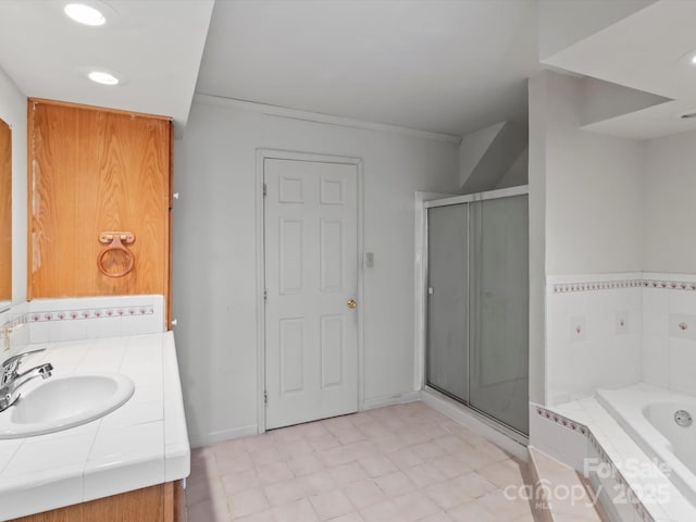 bathroom with recessed lighting, vanity, baseboards, a shower stall, and a bath