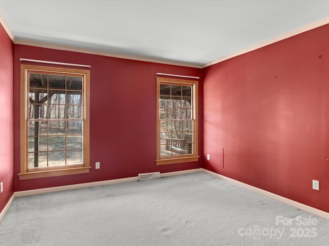 unfurnished room with carpet floors, baseboards, visible vents, and ornamental molding