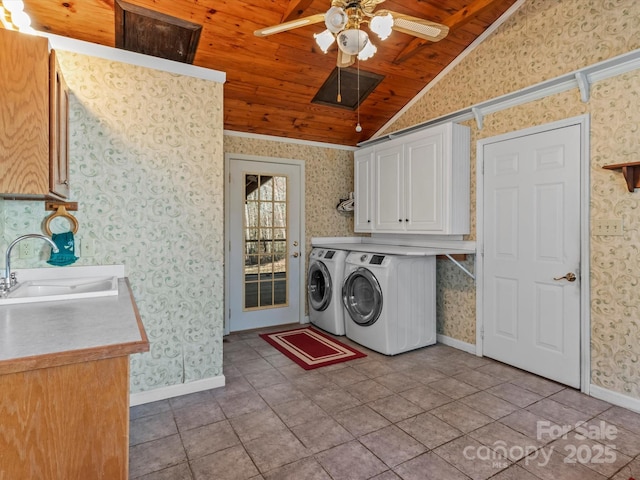 laundry room with independent washer and dryer, a sink, cabinet space, and wallpapered walls