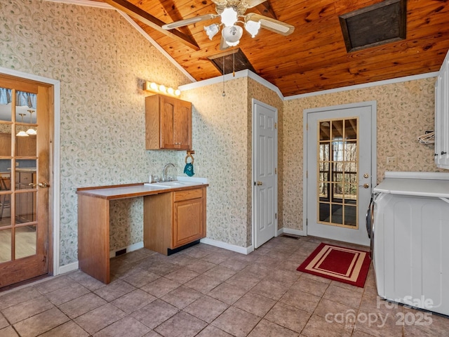 kitchen featuring wallpapered walls, baseboards, wooden ceiling, vaulted ceiling, and a sink