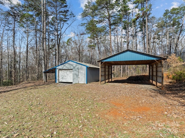 view of outbuilding featuring an outbuilding, a carport, and driveway