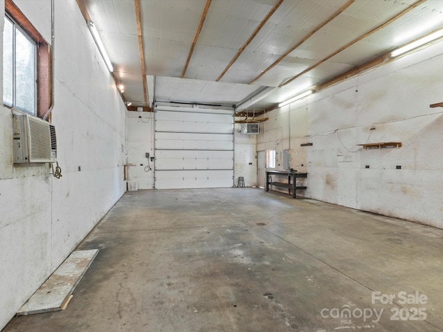 garage with a wall mounted AC and electric panel