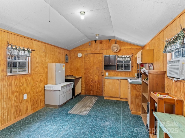 kitchen with wooden walls, dark floors, brown cabinets, vaulted ceiling, and open shelves