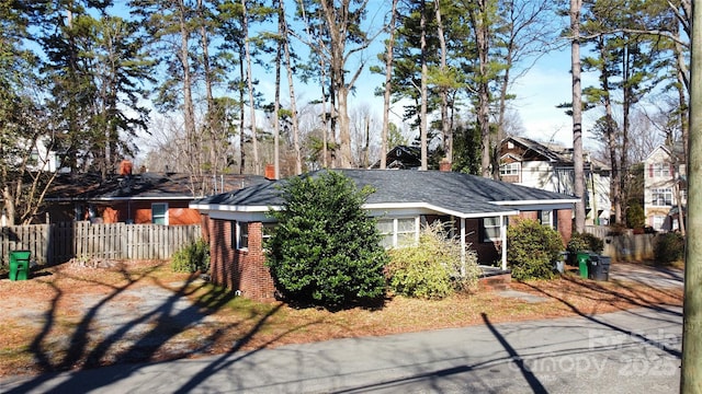 ranch-style home with brick siding and fence