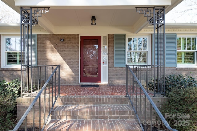 doorway to property with brick siding