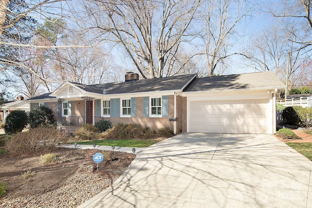 view of front of property featuring concrete driveway, a garage, brick siding, and a chimney