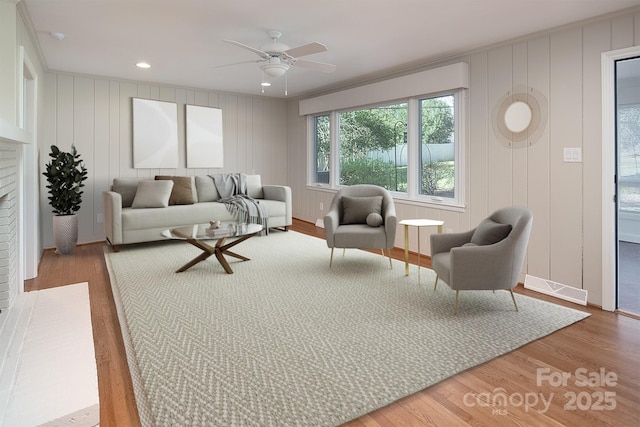 living area with visible vents, recessed lighting, a ceiling fan, and wood finished floors