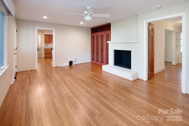 unfurnished living room with visible vents, recessed lighting, a fireplace, light wood finished floors, and ceiling fan