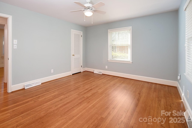 unfurnished bedroom with light wood-type flooring, visible vents, and baseboards