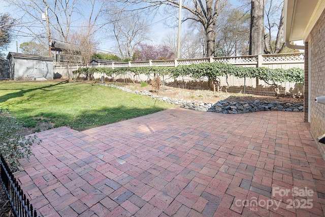 view of patio with a storage unit, an outdoor structure, and a fenced backyard