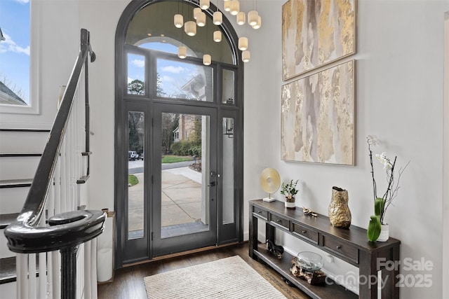 foyer featuring stairway, a high ceiling, and wood finished floors