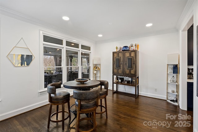 dining area featuring baseboards, ornamental molding, and dark wood-style flooring