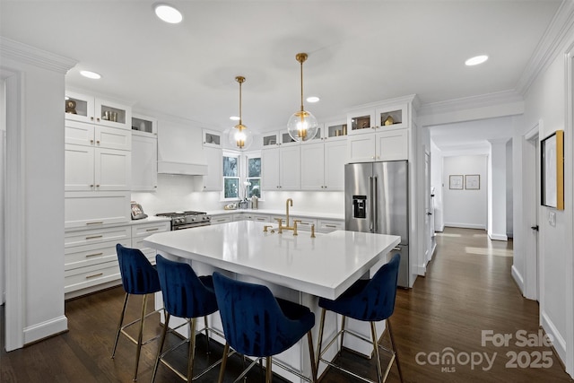 kitchen with custom exhaust hood, a breakfast bar area, stainless steel appliances, light countertops, and a sink