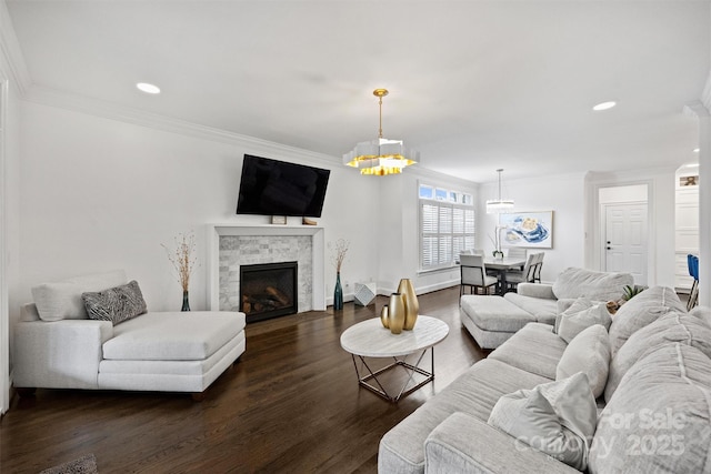 living area featuring dark wood-style floors, recessed lighting, a fireplace, and ornamental molding