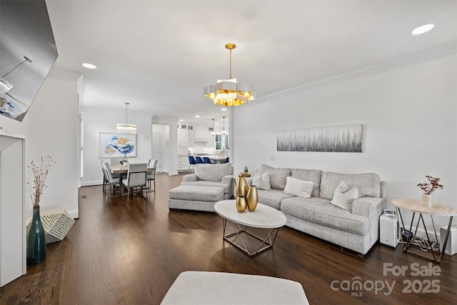 living room featuring dark wood-style floors, recessed lighting, a notable chandelier, and crown molding