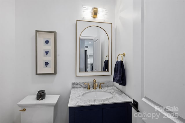 bathroom featuring toilet and vanity