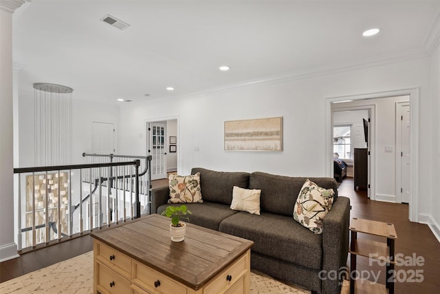 living area with crown molding, visible vents, dark wood-style flooring, and recessed lighting