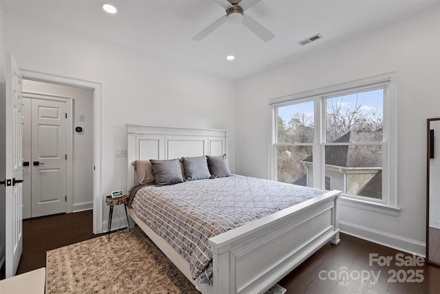 bedroom with recessed lighting, dark wood finished floors, visible vents, and baseboards