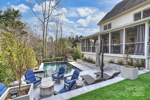 pool featuring a fire pit, a patio, and a sunroom