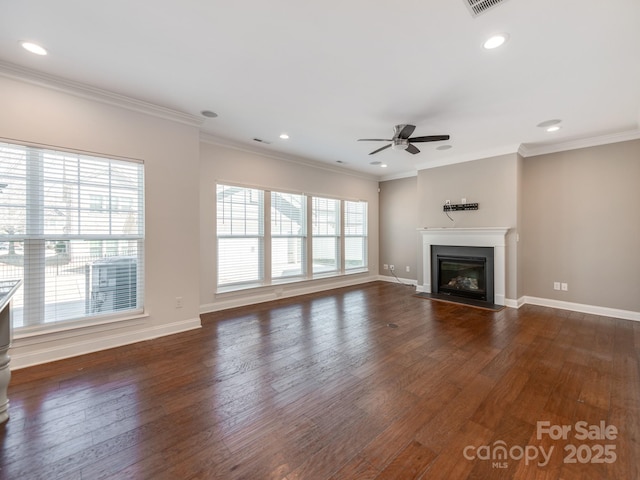 unfurnished living room featuring a fireplace with flush hearth, ornamental molding, baseboards, and wood finished floors