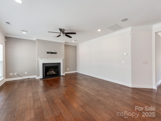 unfurnished living room featuring a fireplace with flush hearth, crown molding, and wood finished floors