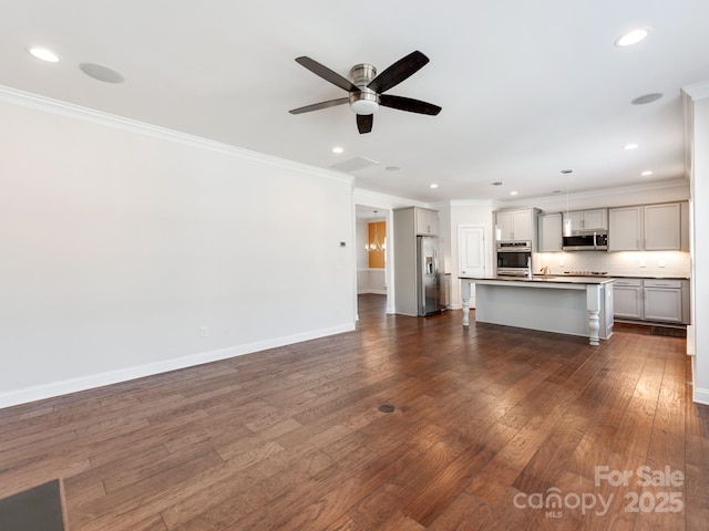 unfurnished living room with crown molding, dark wood finished floors, baseboards, and ceiling fan