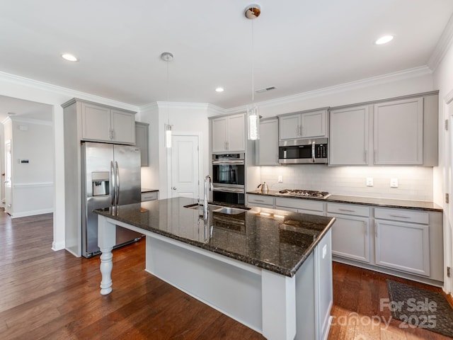 kitchen featuring appliances with stainless steel finishes, dark wood finished floors, decorative backsplash, and gray cabinetry