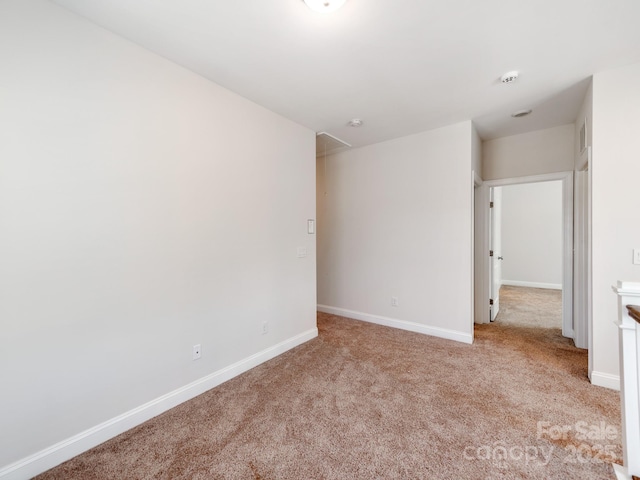 unfurnished bedroom featuring carpet floors, attic access, visible vents, and baseboards