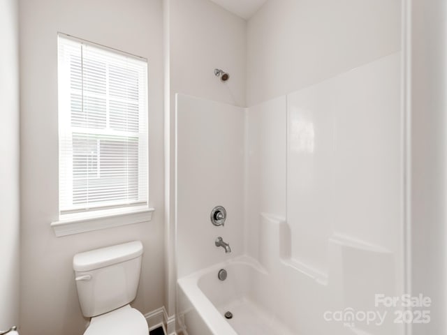 bathroom featuring washtub / shower combination and toilet