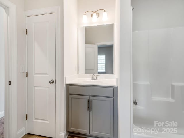 bathroom featuring walk in shower, vanity, and a bath