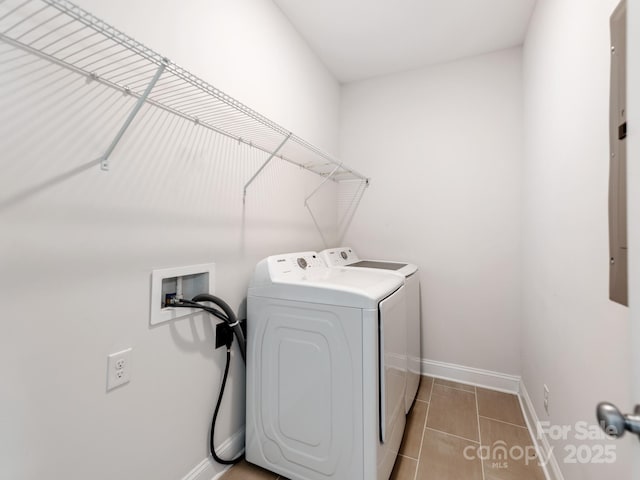 laundry room featuring washer and dryer, laundry area, baseboards, and tile patterned floors