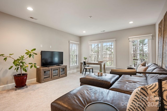 carpeted living area featuring plenty of natural light, recessed lighting, and visible vents