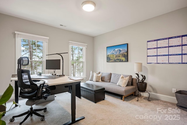 home office with visible vents, light carpet, and baseboards