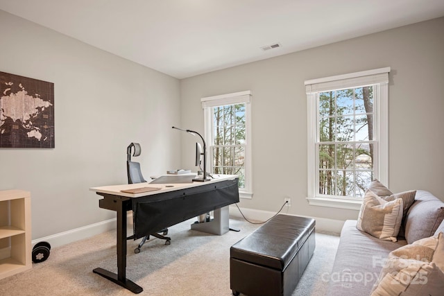 home office featuring a wealth of natural light, baseboards, carpet floors, and visible vents