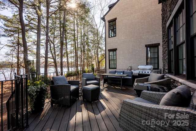 deck with grilling area and an outdoor hangout area