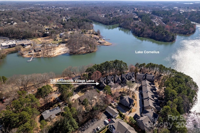 aerial view featuring a wooded view and a water view