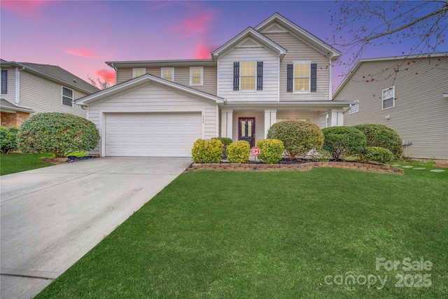 traditional-style home featuring an attached garage, driveway, and a lawn