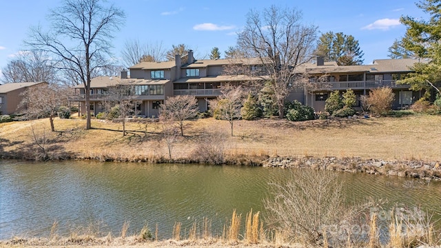 back of house featuring a water view