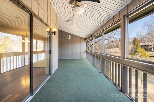 unfurnished sunroom with lofted ceiling and ceiling fan