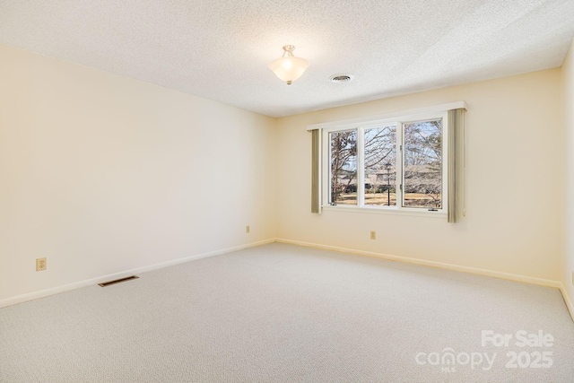 unfurnished room featuring visible vents, light colored carpet, and baseboards